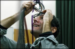 Brown examines a section of 16 mm film. (photo by Donn Young