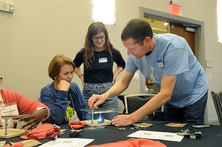 Goldstein helps teachers assemble the microscopes. (photo by Donn Young)