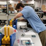 Biomedical engineering graduate student Thomas Kierski works on the ventilator prototype at the manufacturing facility of Toshiba Global Commerce Solutions in Research Triangle Park. (Photo by Toshiba Global Commerce Solutions)