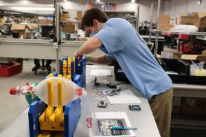 Biomedical engineering graduate student Thomas Kierski works on the ventilator prototype at the manufacturing facility of Toshiba Global Commerce Solutions in Research Triangle Park. (Photo by Toshiba Global Commerce Solutions)