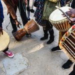 Drums play a large role in African music, according to UNC-Chapel Hill researcher Petal Samuel. Photo shows a closeup of people hitting drums.