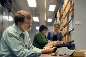 Massey Award winner Steve Davis (left, foreground) in the Hamilton archaeology archive. (photo by Donn Young)