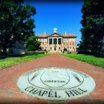 Photo of Old Well with campus seal in the foreground by Donn Young