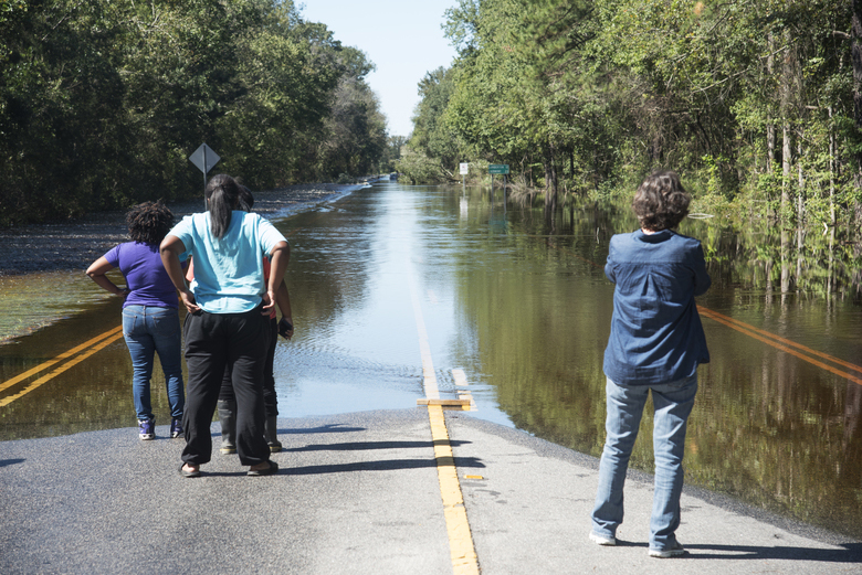 Residents from Robeson County examine the flooding after Hurricane Matthew.