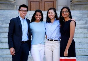 Four members of the Asian American Center Campaign team posing in front of Wilson Library. 