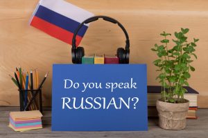 Sign in front of headphones and a flag says: "Do you speak Russian?"