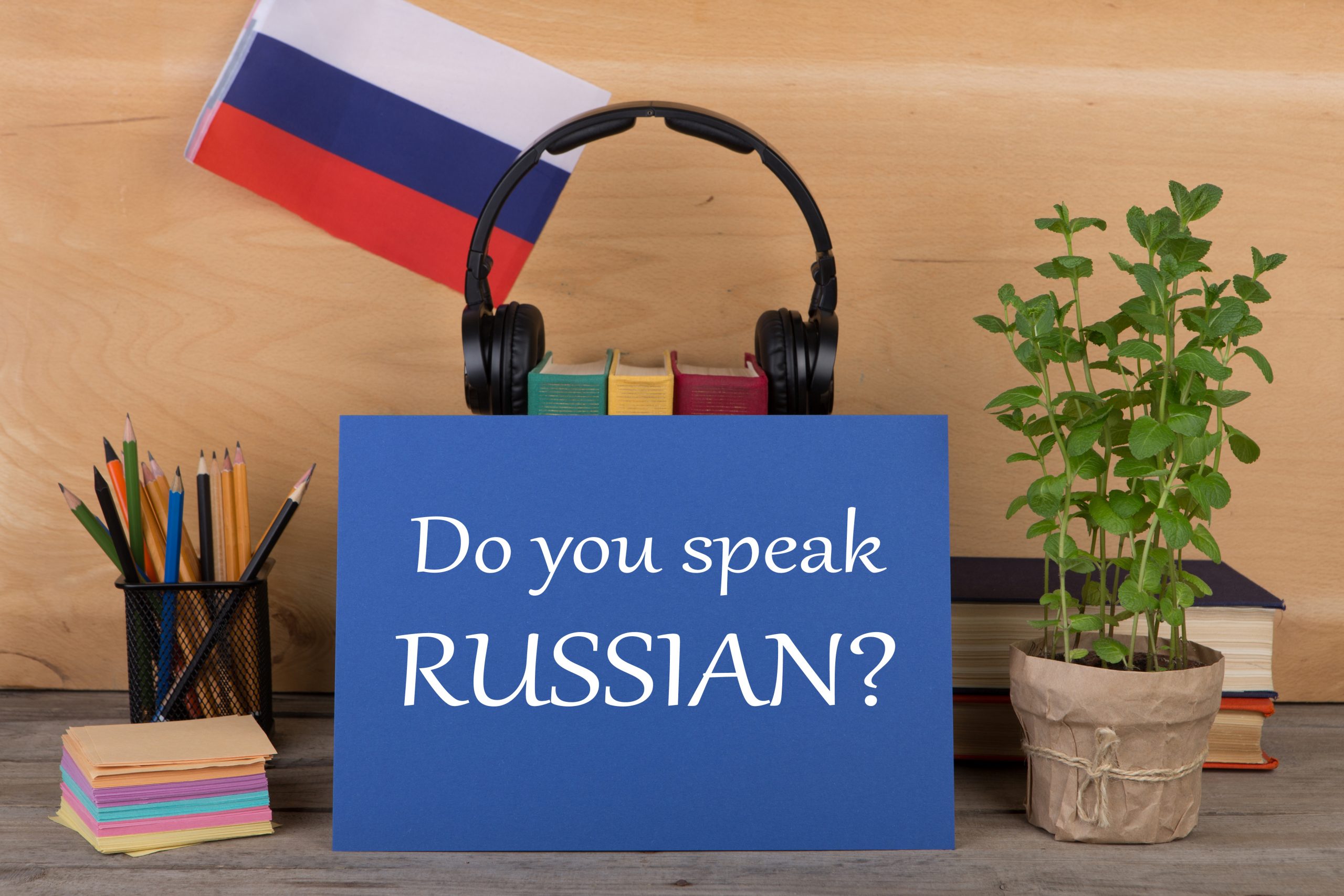 Sign in front of headphones and a flag says: "Do you speak Russian?"