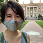 Keely Muscatell wearing a face mask in front of the South Building at UNC-Chapel Hill.