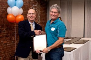 Ramsey (right) receives one of several patent plaque awards presented by Provost Bob Blouin during the 2019 Celebration of Inventorship.