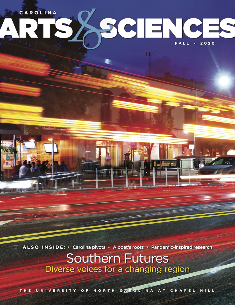 Cover image of Carolina Arts & Sciences magazine, fall 2020 issue, shows a downtown streetscape of Chapel Hill at night, with blurred headlights and street lights marking the landscape.