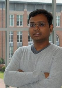 Photo of Shahriar Nirjon standing in front of a building on UNC-Chapel Hill's campus