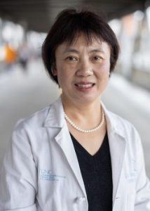 Photo of Lixin Song in a UNC-Chapel Hill lab coat