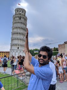 Mohit Bansal poses in front of the Leaning Tower of Pisa in Italy
