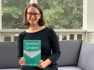Tania Jenkins holds a copy of her new book, "Doctor's Orders."