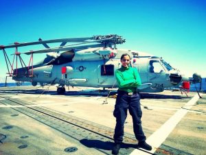 Dedra Ming stands in front of a helicopter.