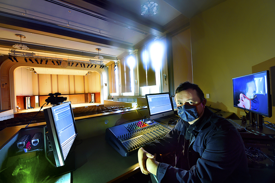Jesse Moorefield in the control booth in the James and Susan Moeser Auditorium in Hill Hall. (photo by Donn Young)