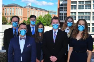 group of innovators shown wearing their new mask invention