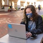 Students studying on campus on Feb. 9, 2021. (Johnny Andrews/UNC-Chapel Hill) (with masks and laptops)