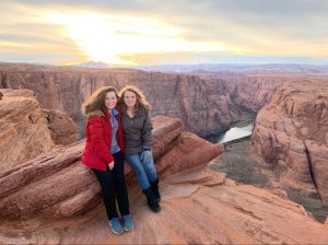 Photo of Youngstrom and her sister smiling in front of a sunset background in Arizona