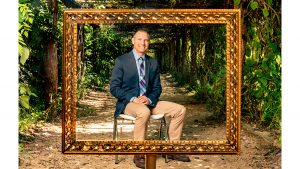 Carolina clinical psychology professor Jonathan Abramowitz poses for a portrait under the arbor in Coker Arboretum. (Johnny Andrews/UNC-Chapel Hill)