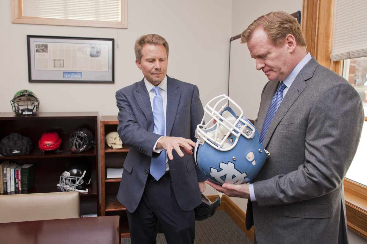 Dr. Kevin Guskiewicz and Roger Goodell discuss the sensors placed in a football helmet that are used in the Helmet Impact Telemetry (HIT) Study. Goodell, Commissioner of the National Football League (NFL), was the Blyth Lecturer for the Exercise and Sport Science (EXSS) Department at the University of North Carolina at Chapel Hill with the lecture being held inside Alumni Hall at the George Watts Hill Alumni Center. Goodell was invited by Dr. Kevin Guskiewicz, EXSS Department Chair, Kenan Distinguished Porfessor and Director of the Matthew Gfeller Sport-Related Traumatic Brain Injury Research Center (Gfeller Center). Guskiewicz's research on concussions has reshaped the way the NFL, military and many other sports are approaching injuries to the head, neck and spine. Goodell and Guskiewicz, also a member of the NFL's head, neck and spine committee, made the rounds at the EXSS department including a presentation about the Gfeller Center research and an introduction Q&A about the the Sports Management program at UNC-Chapel Hill. Goodell also took a few minutes to meet two Carolina football athletes and head football coach Larry Fedora. (photos © Kevin Seifert for EXSS)