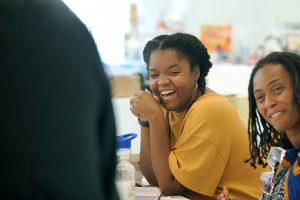 Closeup of a female African American teacher laughing.
