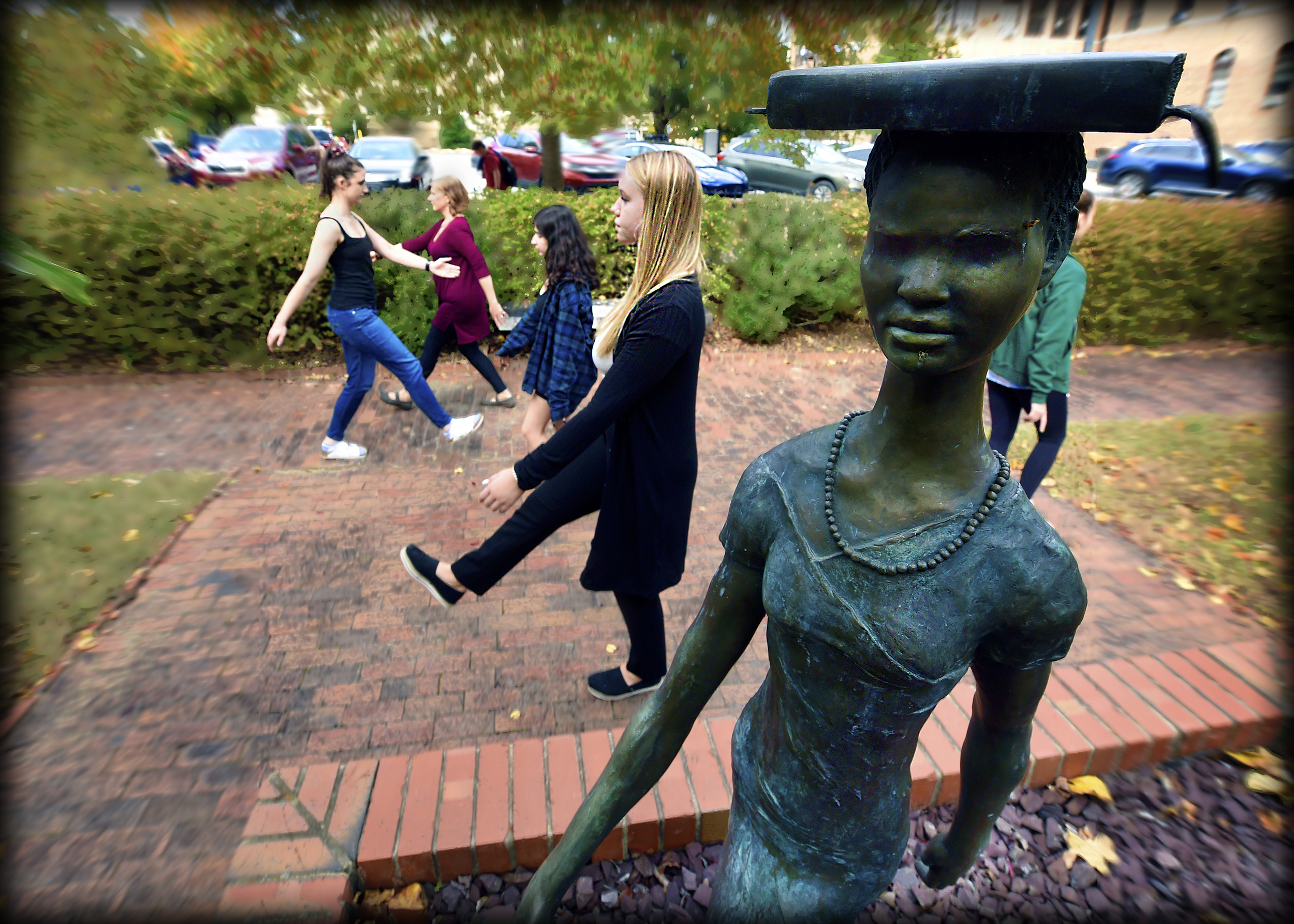 Student dancers dance amid the sculptures in the Hamilton scuplture garden.