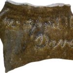 A piece of pottery with writing inscribed in it