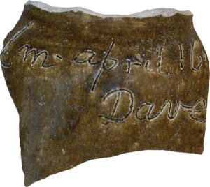 A piece of pottery with writing inscribed in it 