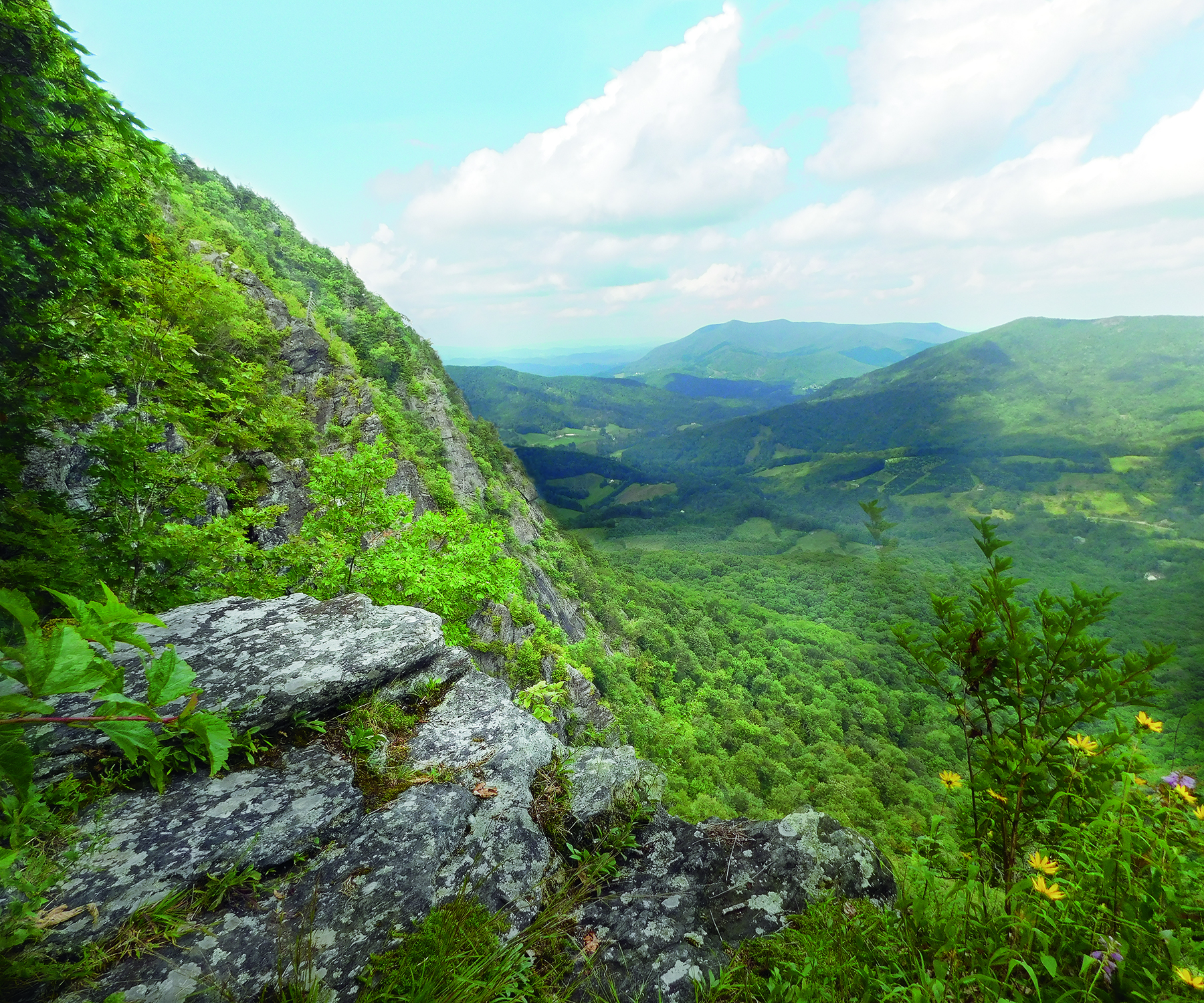 Photo of a mountain bluff with mountains in the distance, Ashe County.