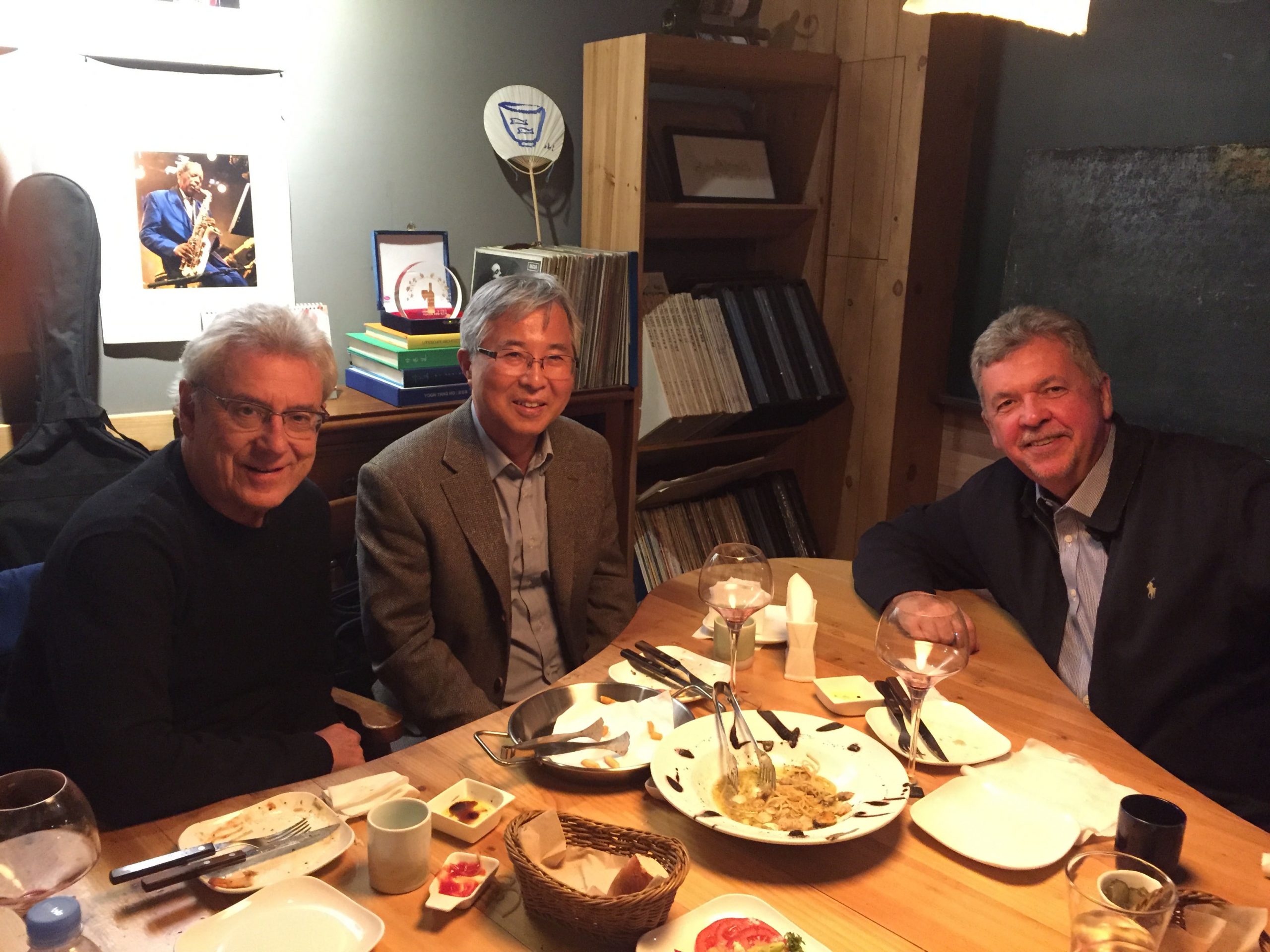 The authors sit around a dinner table at a restaurant.