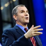 Frank Bruni speaks standing at a podium.