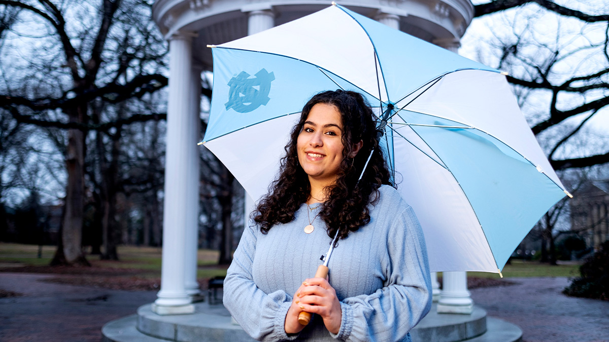Dalal Azam stands with an umbrella near the Old Well.