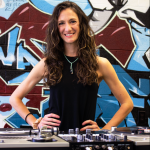 Kelli Smith-Biwer stands behind turntables in UNC's Beat Lab.