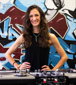 Kelli Smith-Biwer stands behind turntables in UNC's Beat Lab.