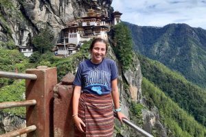Alaina stands on the side of a cliff in Bhutan.