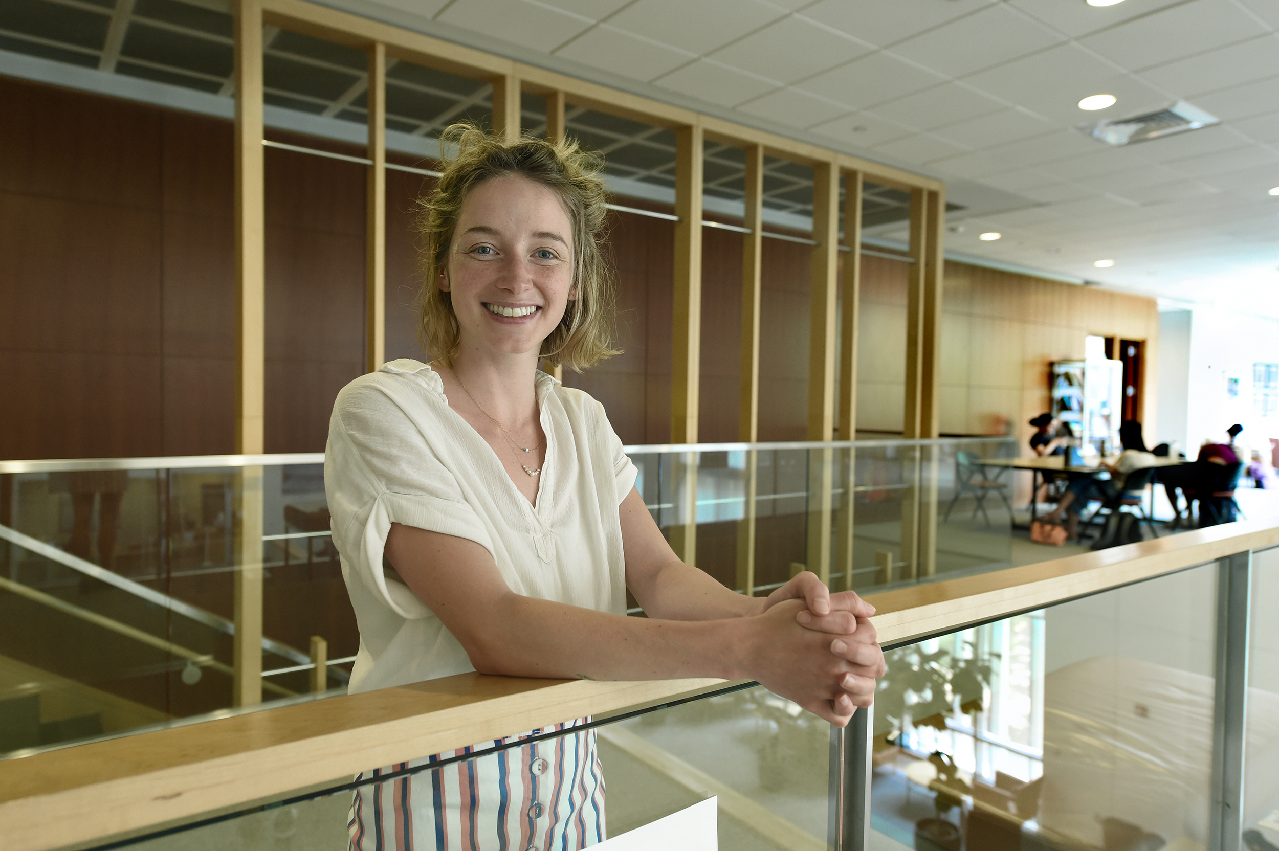 Catherine Haas stands near the railing on the second floor of the FedEx Global Education Center.