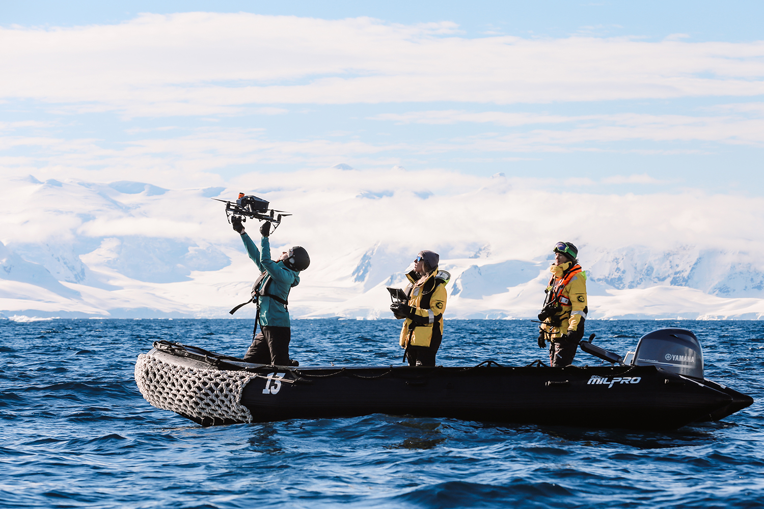 Chloe Lew catches a drone flown by McPherson after capturing images of whales during a research expedition to Antarctica. (photo by Leslie Hsu Oh)