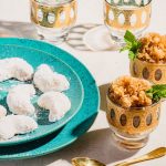 pecan shortbread on a blue plate with coffee granita in little gold bowls surrounding it.