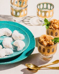 pecan shortbread on a blue plate with coffee granita in little gold bowls surrounding it.