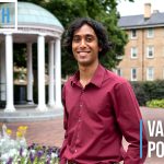 Varun Potlapalli stands in front of the Old Well. A graphic overlaid on top of the image reads #GDTBATH Varun Potlapalli