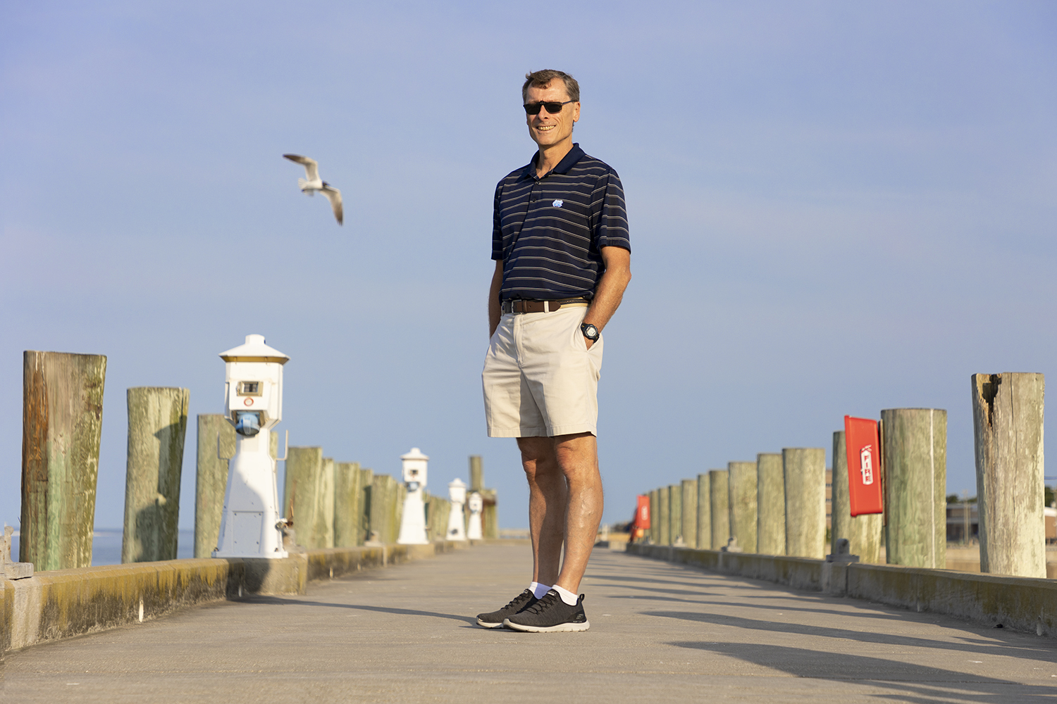 Rick Luettich stands on a boardwalk.