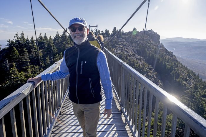 Raul Reis smiles for the camera on a bridge at the top of Grandfather Mountain.