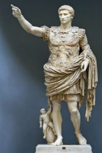 The statue Augustus of Prima Porta, depicting Augustus in armor raising his right hand to point toward the sky.