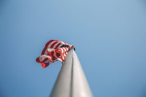 An American flag is raised on a flagpole