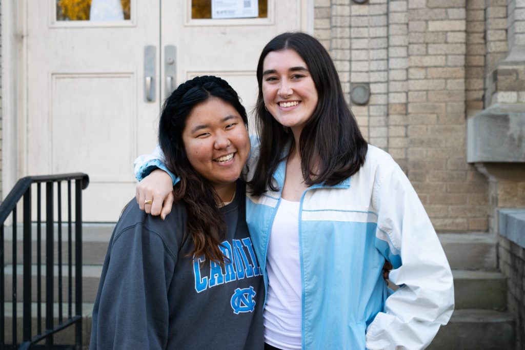 Nuria Shin and Casey Mentch stand next to one another on the steps of Hill Hall, the music department's main building.
