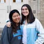 Nuria Shin and Casey Mentch stand next to one another on the steps of Hill Hall, the music department's main building.