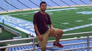 Gerson Aguilera stands in Kenan Stadium in the bleachers.