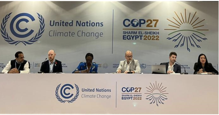 Angel Hsu joins other panelists at a table at the COP27 event.
