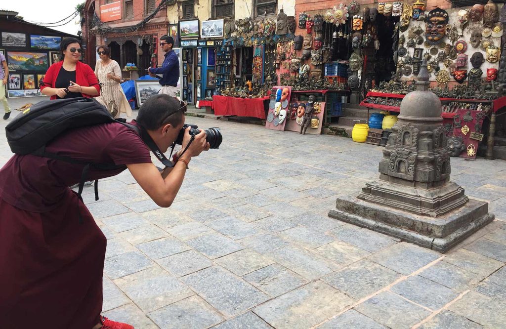 A red-robed monk practices photogrammetry techniques in Nepal. (photo by Lauren Leve)